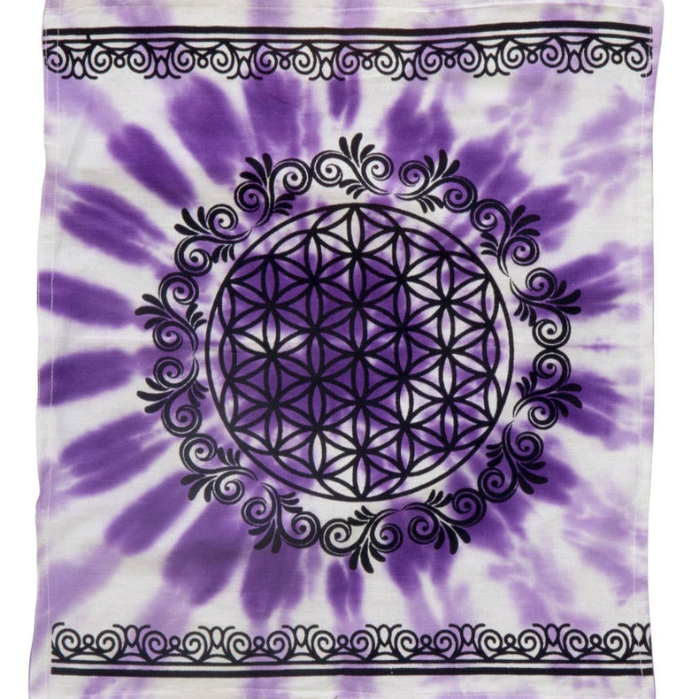 Tie-dye fabric with a black mandala design on a white and purple background