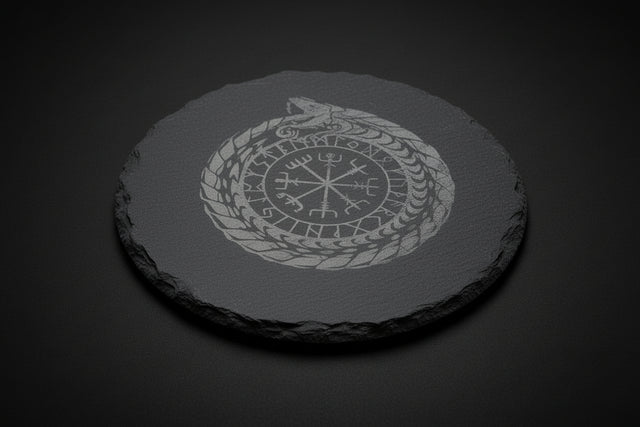 Round slate altar tile engraved with Nordic ouroboros and runic-style symbol used as a ritual surface.