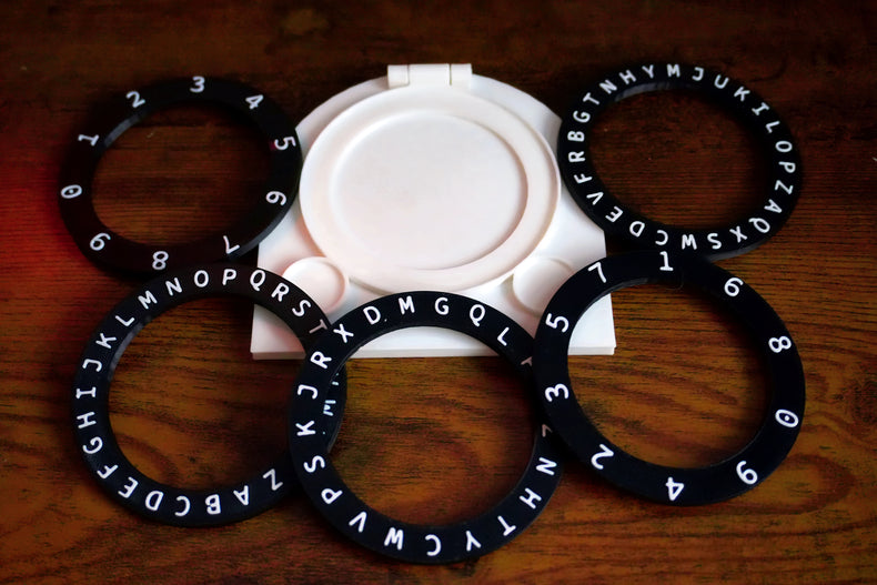 Black rings with letters and numbers on a white background