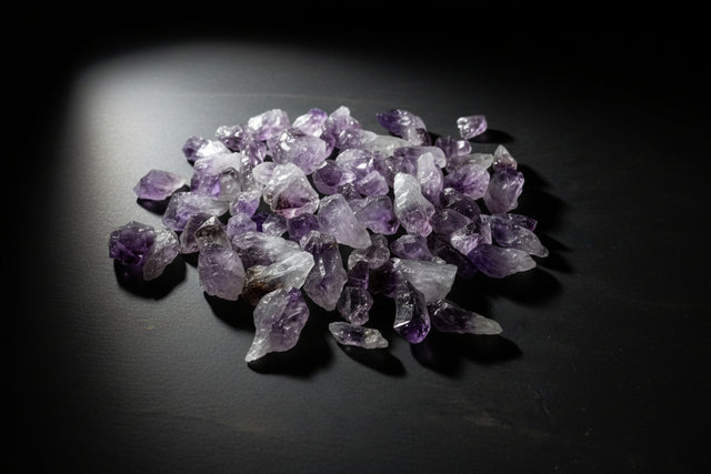 Amethyst crystals on a gray surface