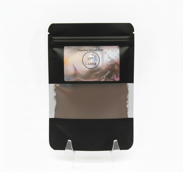 Black packaging of Ancestral Ritual Dust with a visible brand label on a white background