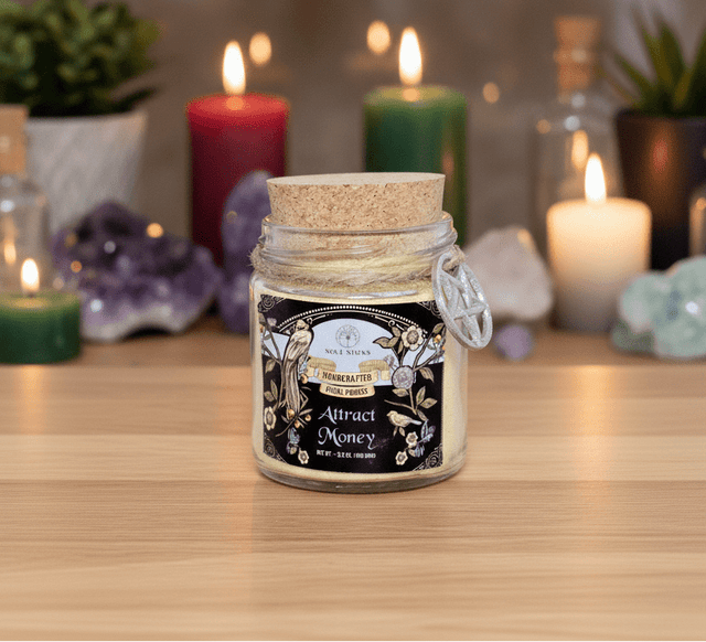 Jar candle with cork lid on a wooden surface with candles and decorative items in the background