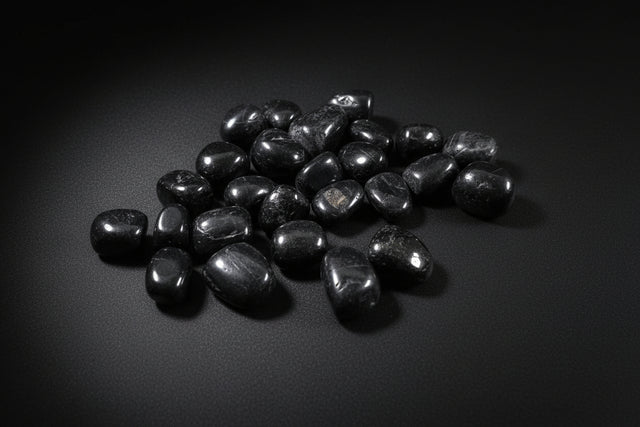 Black stones on a wooden surface
