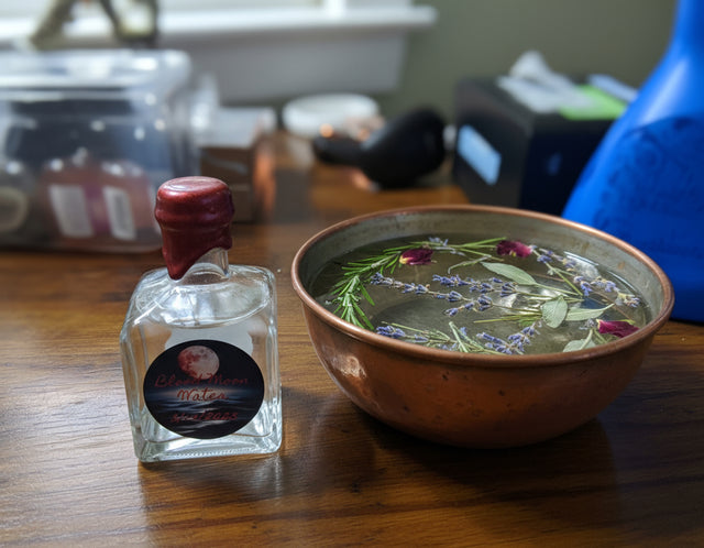 Small glass bottle with a red cap on a wooden surface