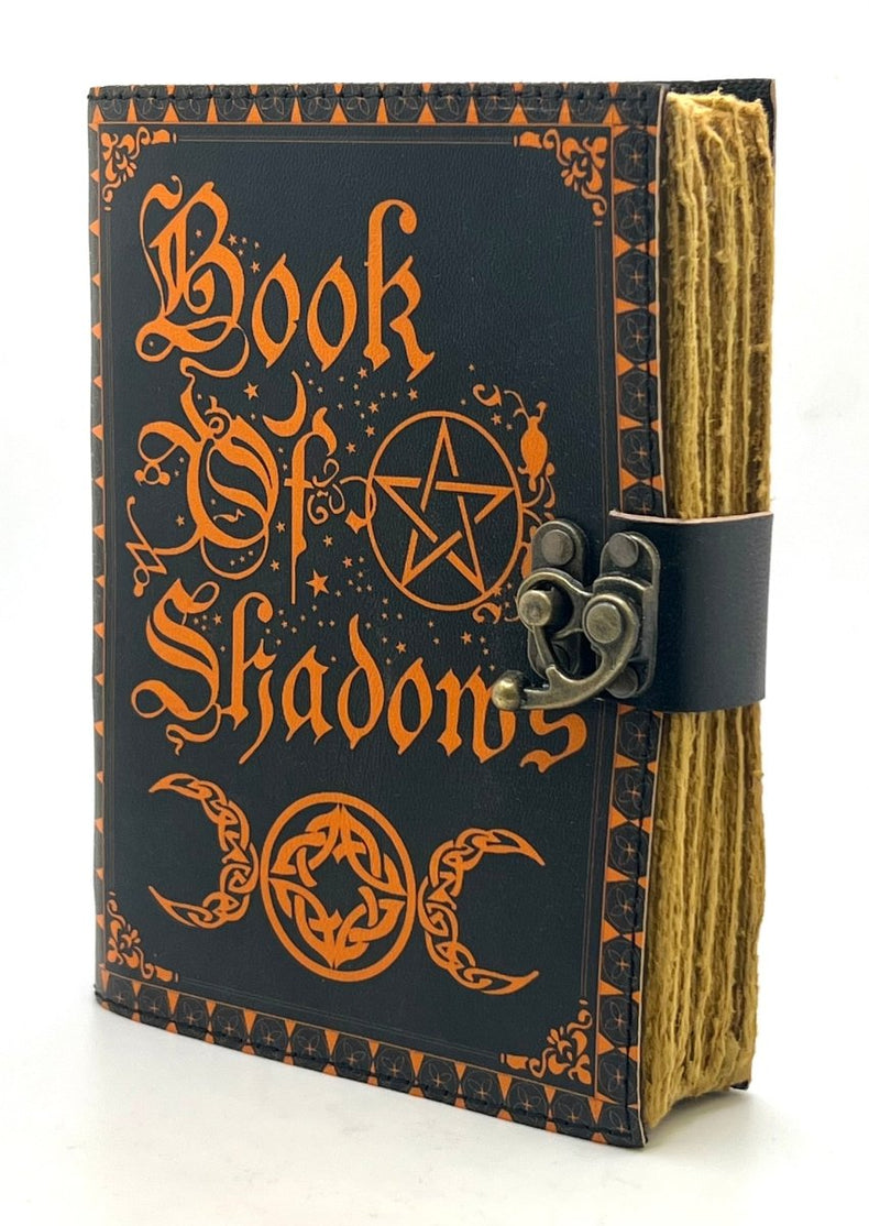 Book of Shadows with black cover and orange text on a white background