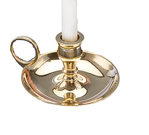Gold candle holder with a white candle on a white background