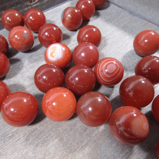 Red beads on a wooden surface