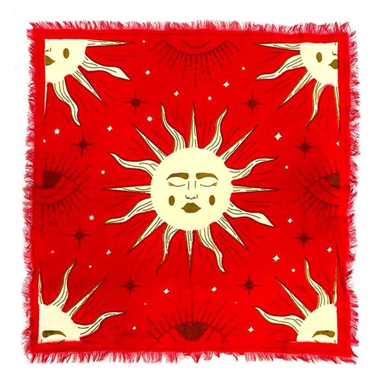 Red scarf with gold sun and moon designs on a white background