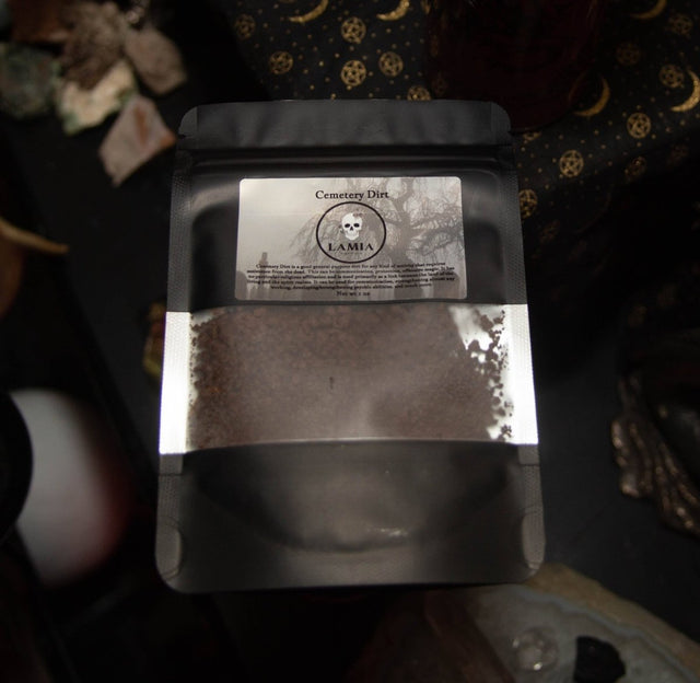 Cememtery Dirt Dark brown powder in a labeled packaging on a patterned surface