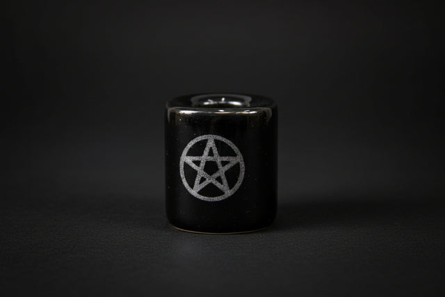 Black ceramic holder with pentagram design on a white background