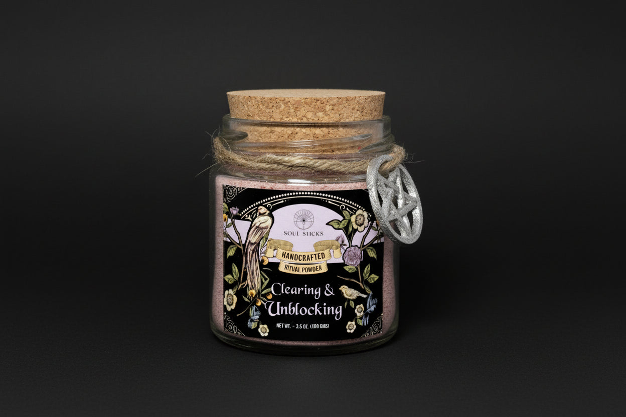 Glass jar with cork lid containing 'Clearing & Unblocking' ritual powder on a white background