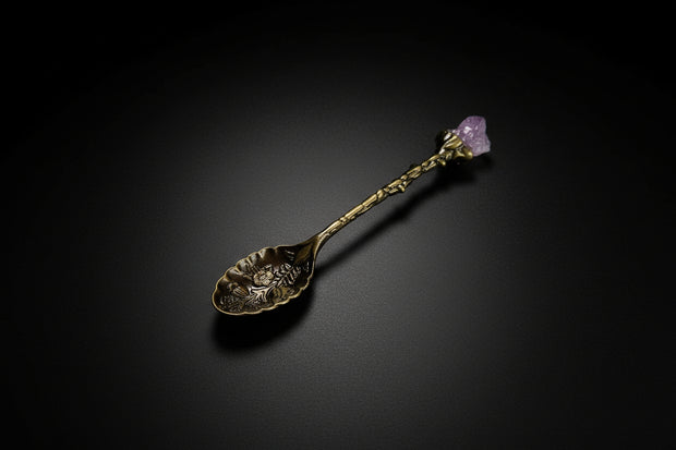 Gold-tone decorative altar spoon with purple cluster-style topper