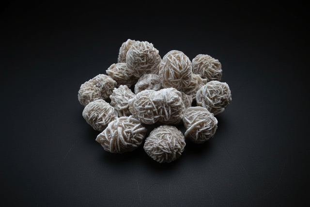 Frosted spherical selenite clusters on a wooden surface