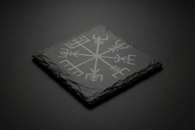 Black slate stone with engraved symbol on a black surface