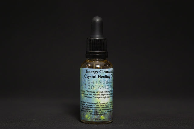 Bottle of Energy Cleansing Crystal Healing Oil with a dropper on a mystical background.