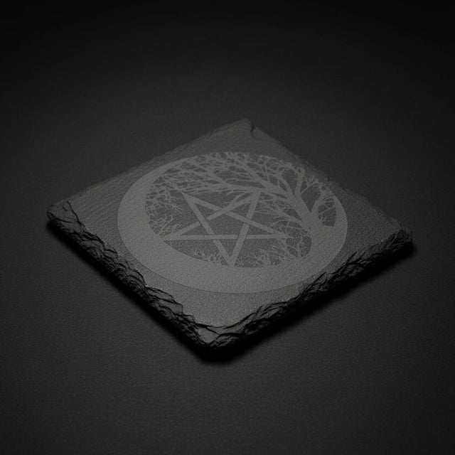 Square slate altar tile engraved with pentagram inside crescent moon and tree design on natural stone surface.