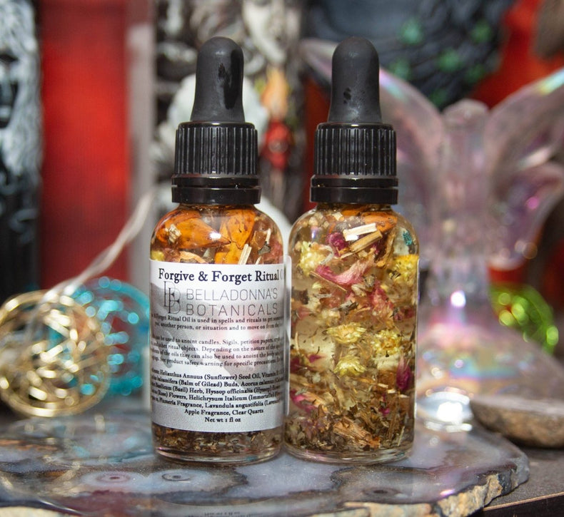 Two bottles of 'Forgive & Forget Ritual' with botanicals on a mystical background.