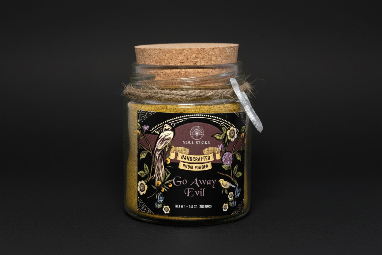 Jar of 'Go Away Evil' ritual powder with decorative label and cork lid on a white background