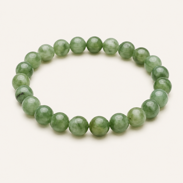 Polished round green mica beaded stretch bracelet with natural green shimmer and mineral flecks.