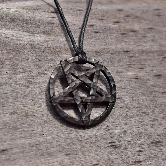 Pentagram pendant on a cord against a wooden background