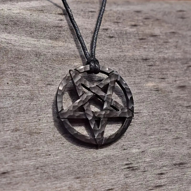 Pentagram pendant on a cord against a wooden background
