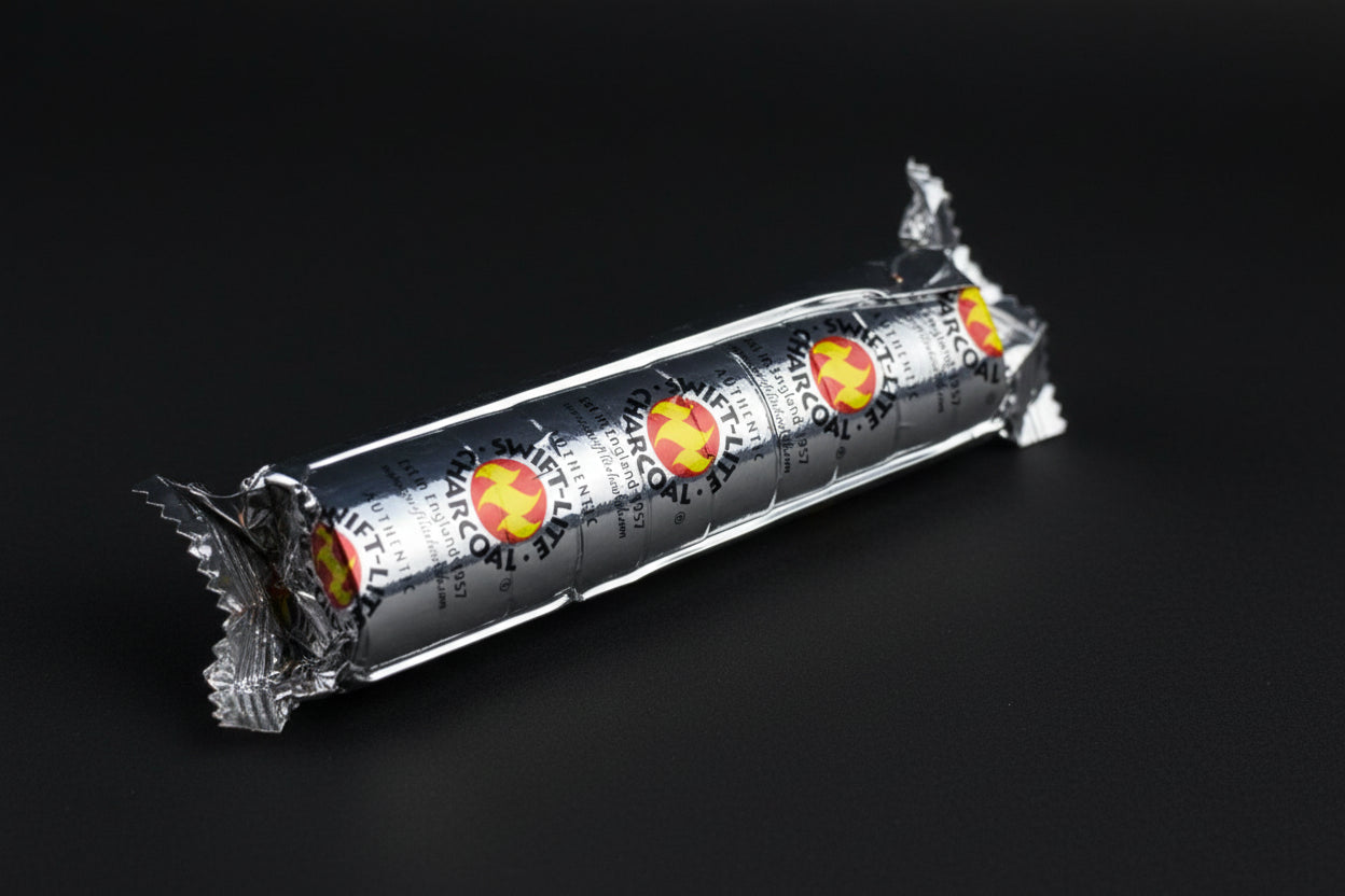 A pack of charcoal discs wrapped in tin foil with a design of a flame on the packaging.