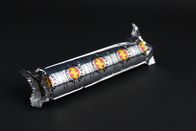 A pack of charcoal discs wrapped in tin foil with a design of a flame on the packaging.