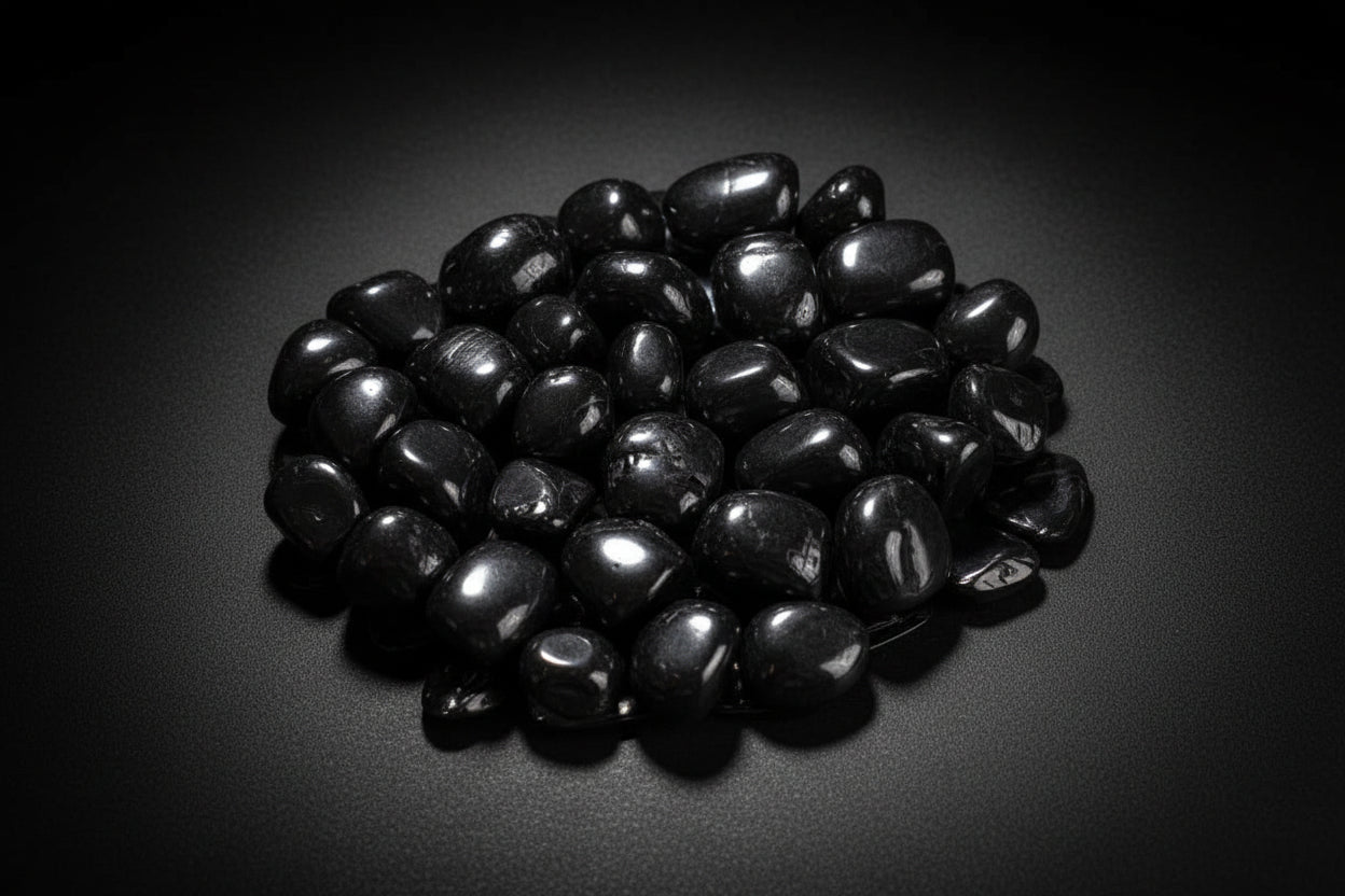 Representative polished black stones sold as Jet; color, luster, shape, polish, and size vary