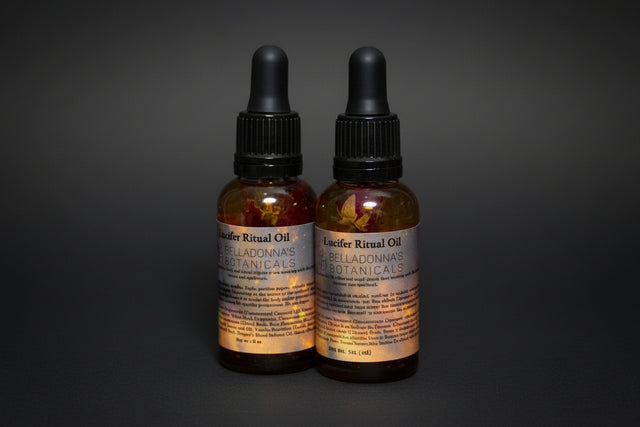 Two bottles of Locifer Ritual Oil with botanicals on a dark background