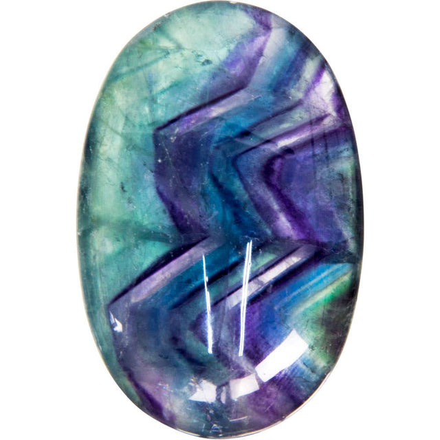 Oval-shaped gemstone with purple and green colors on a white background