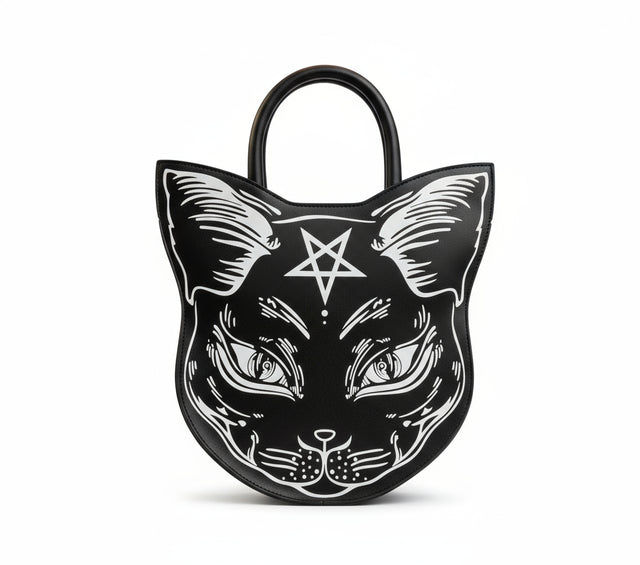 A black handbag in the shape of a cat with a pentagram presented in a mystical and gothic style setting with candles.