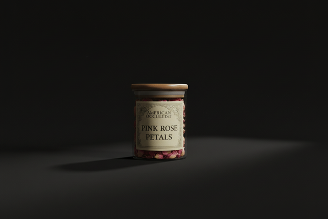A jar with pink rose petals on a black background.