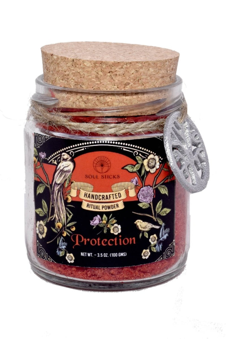 Glass jar with cork lid containing 'Protection' ritual powder, featuring a decorative label.