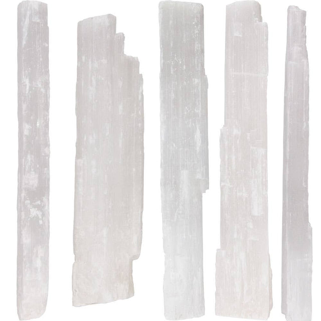 Set of six white selenite sticks on a white background