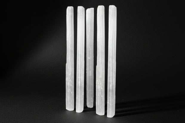 Raw white satin spar gypsum wands measuring approximately 4 to 7 inches