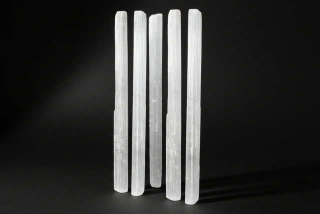 White vertical selenite wands on a white background