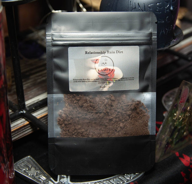 Black coffee bag labeled 'Relationship Ruin Dirt' with a visible brand logo on a metallic surface.
