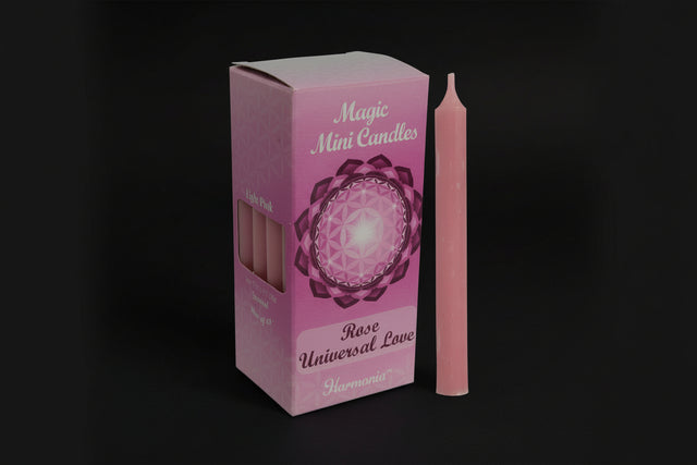 Pink candle with packaging labeled 'Magic Mini Candles Rose Universal Love' on a white background