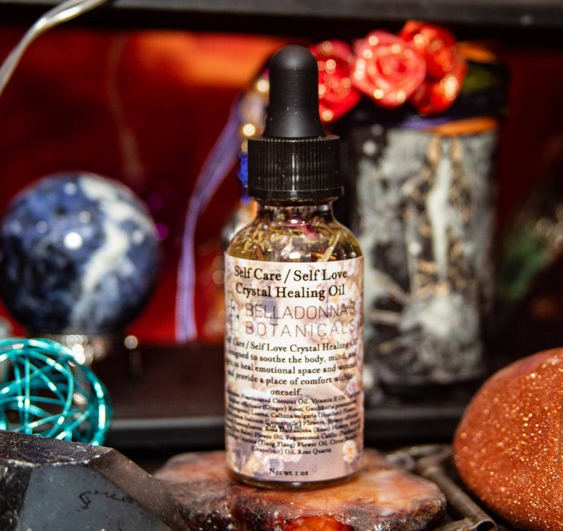 Bottle of 'Self Care / Self Love' crystal healing oil with decorative background