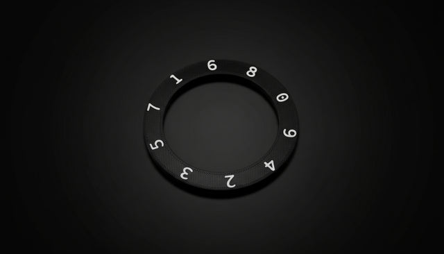 Black ring with numbers on a wooden surface