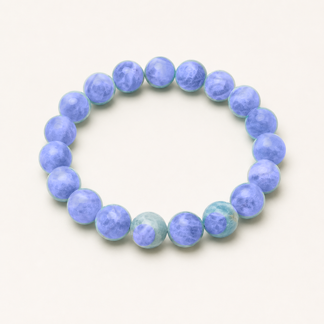 Polished round sodalite beaded stretch bracelet with deep blue color and natural white mottling.