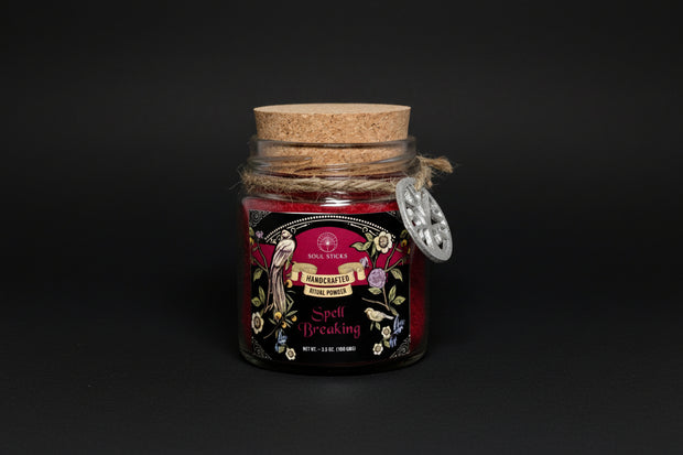 Jar of 'Spell Breaking' ritual powder with decorative label on a white background