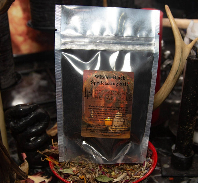 Silver packaging of 'Witch's Black Spellcasting Salt' by Belladonna Botanicals on a dark background.