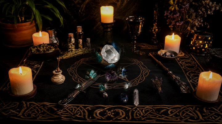 Crystal grid arranged on a candlelit ritual table with a central stone and supporting crystals