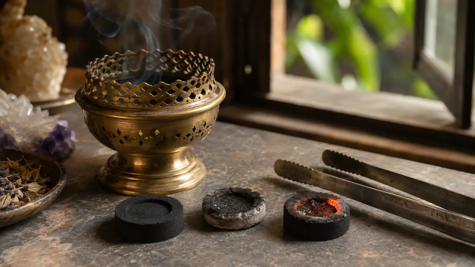 Unlit, extinguished, and glowing incense charcoal discs beside metal tongs and a brass burner