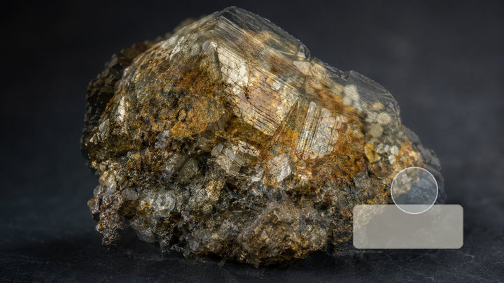 Several mineral specimens arranged with simple identification tools for comparing luster, streak, and transparency.