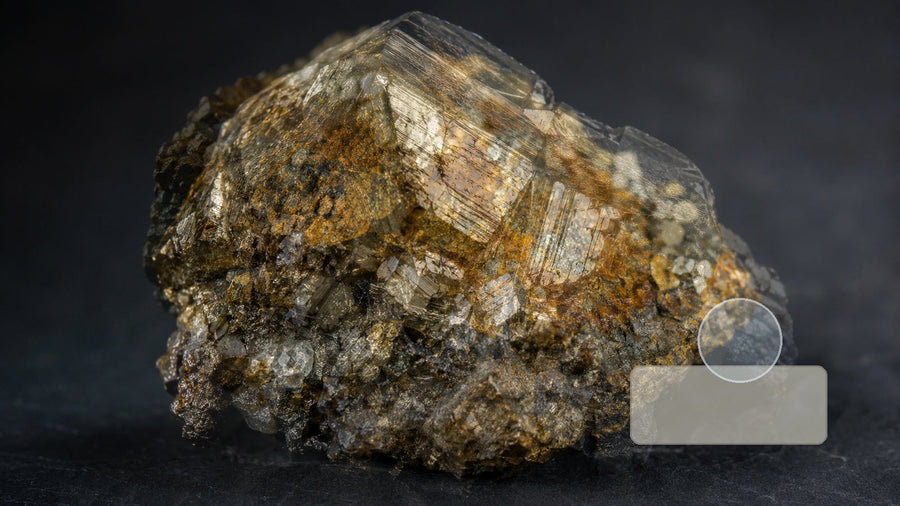Several mineral specimens arranged with simple identification tools for comparing luster, streak, and transparency.