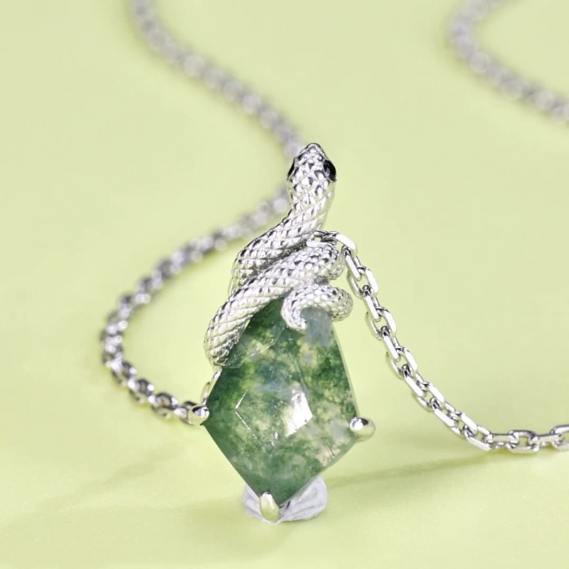 Crystal jewelry gift featuring a green moss agate snake charm necklace in sterling silver