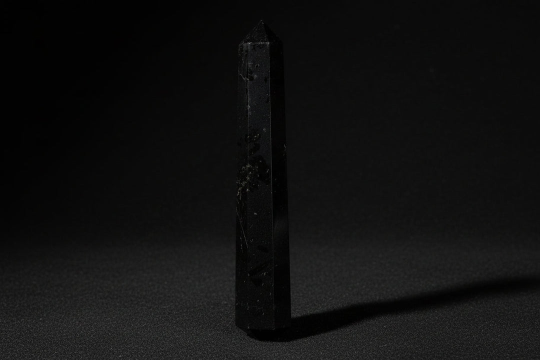 Black tourmaline wand representing crystals traditionally associated with protection and grounding