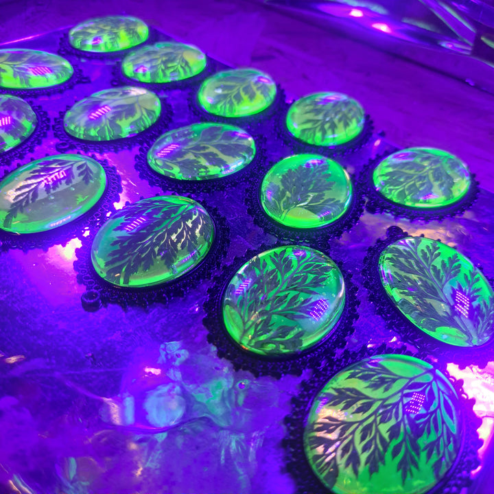 Green holographic fern necklace shown on chain